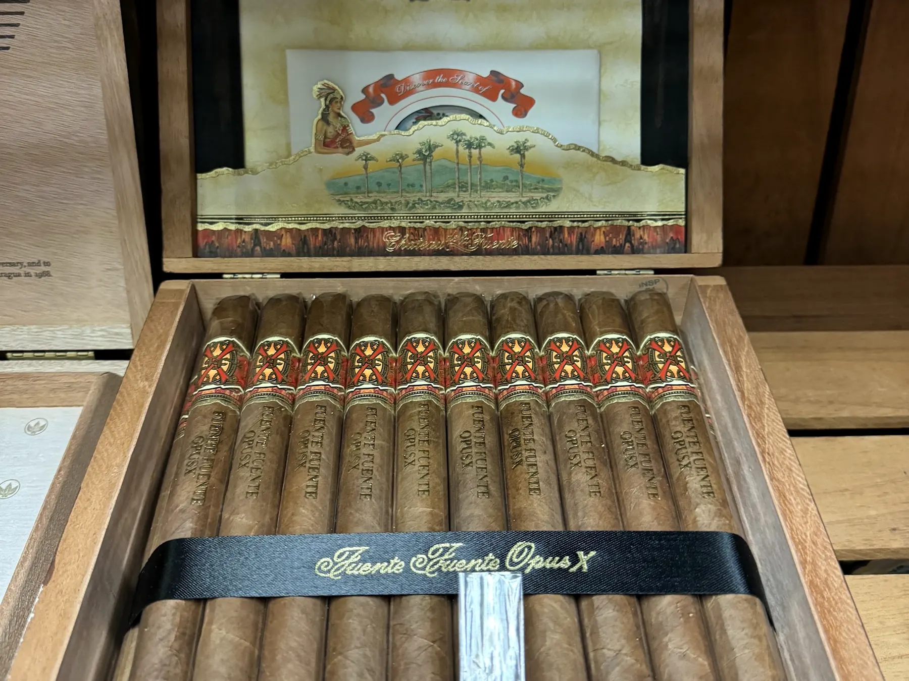 An open cedar box of Fuente Fuente OpusX cigars from the humidor