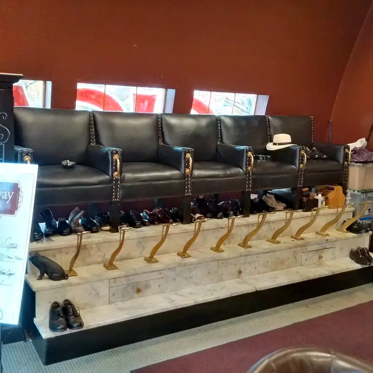Black leather seating along the red wall